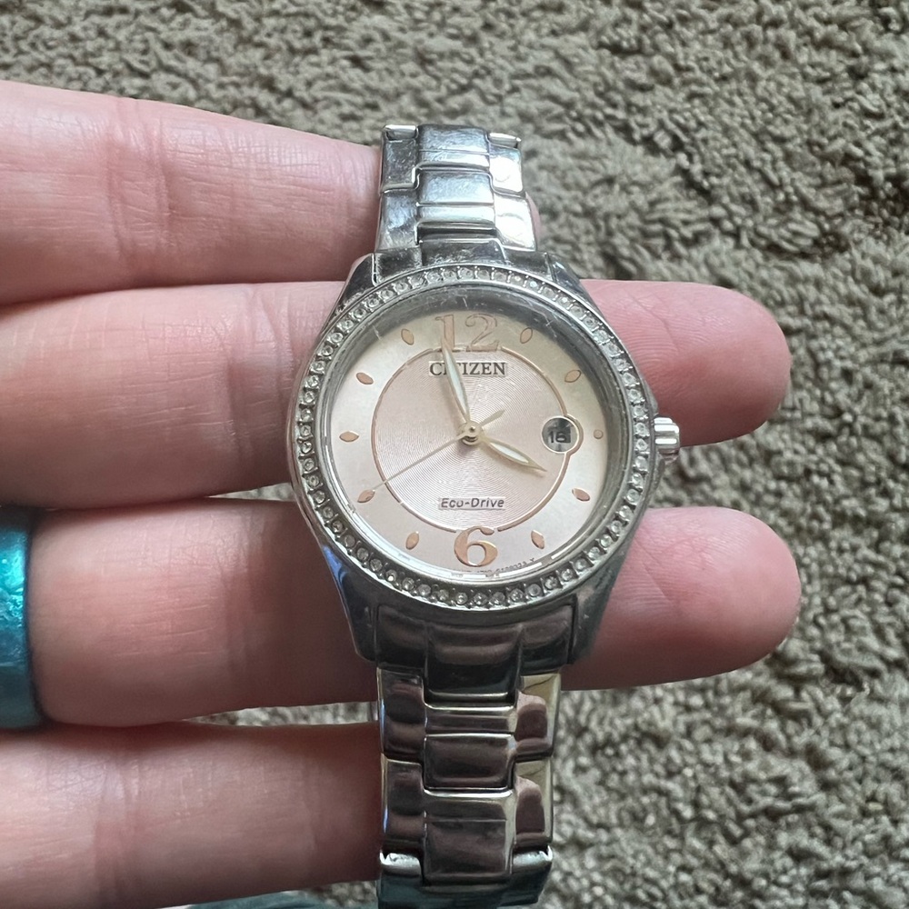 Citizens eco-drive watch. Light pink face with rose gold markings.